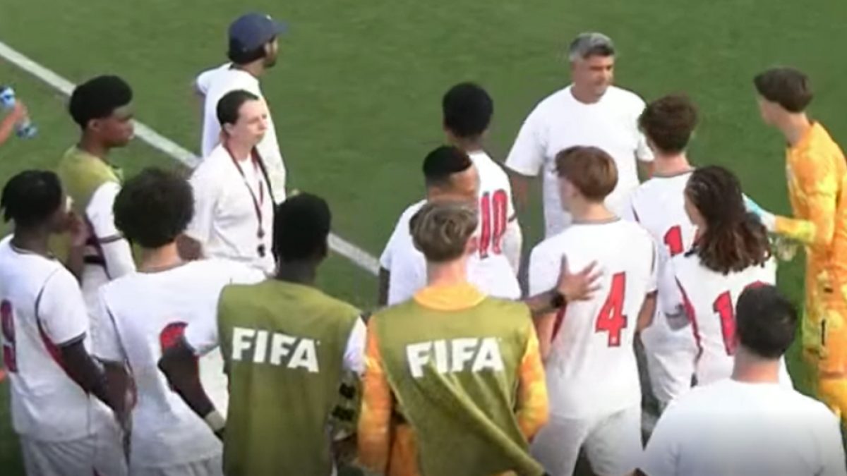 England Under-15 players and coaching staff on the touchline during a match